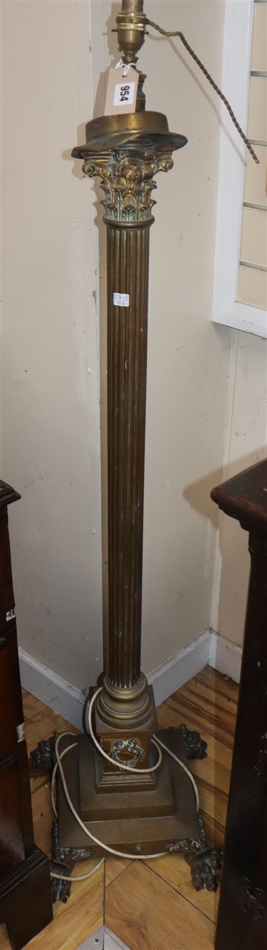 A brass paw footed Corinthian column adjustable standard lamp